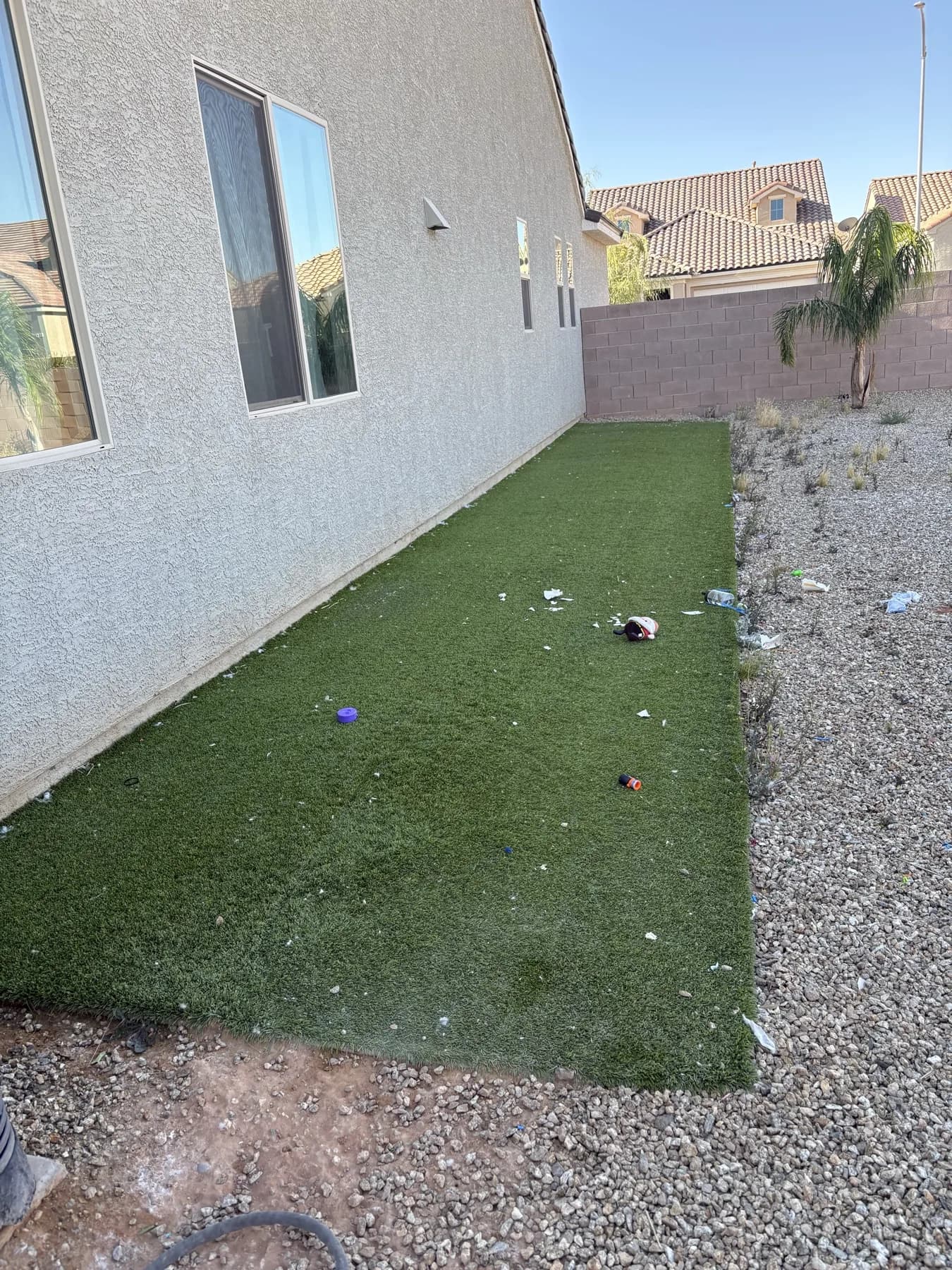 Matted, debris-covered artificial turf in a Mesquite NV backyard before restoration